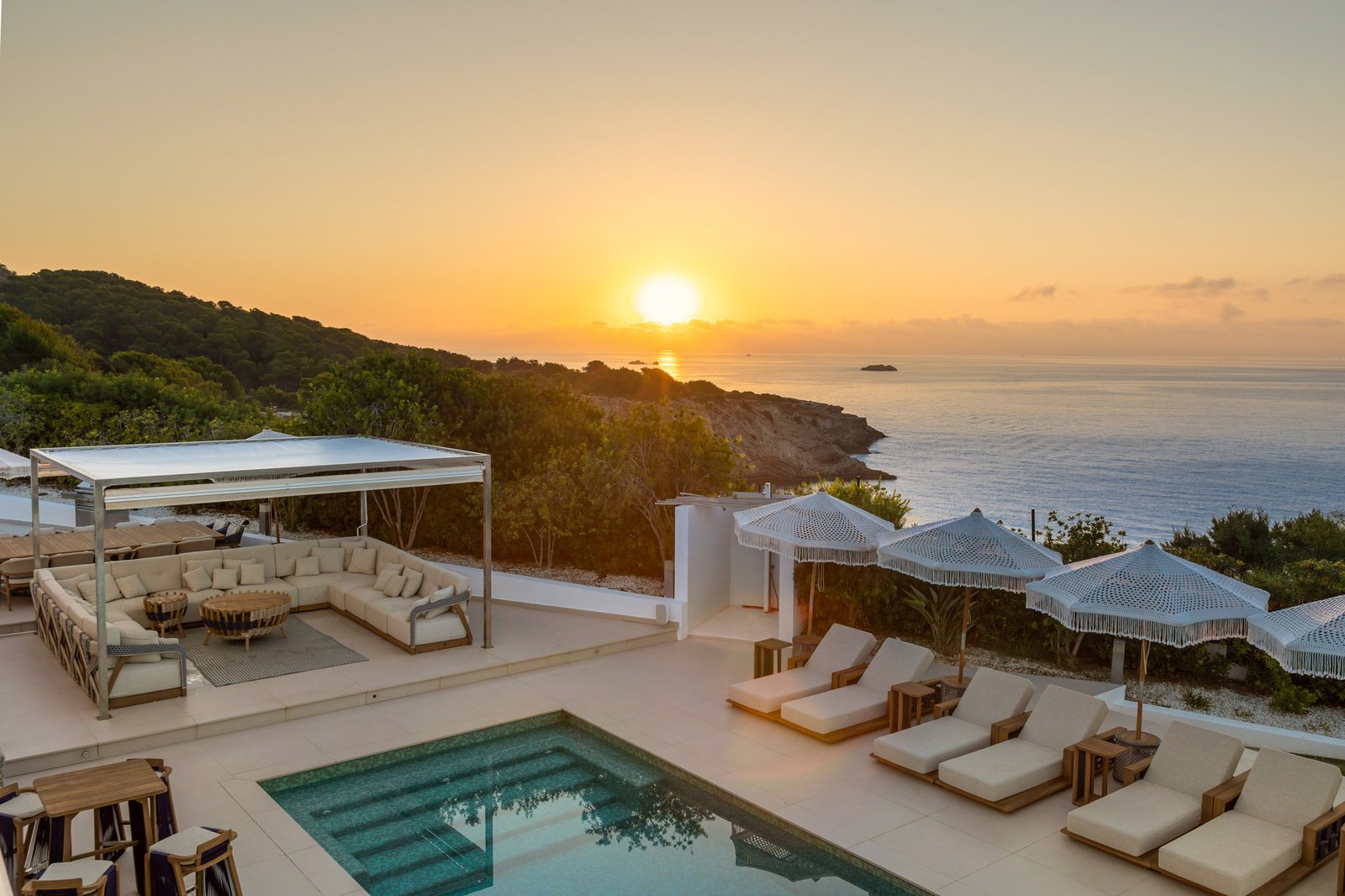 Luxury villa terrace with infinity pool and sunset sea view in Ibiza