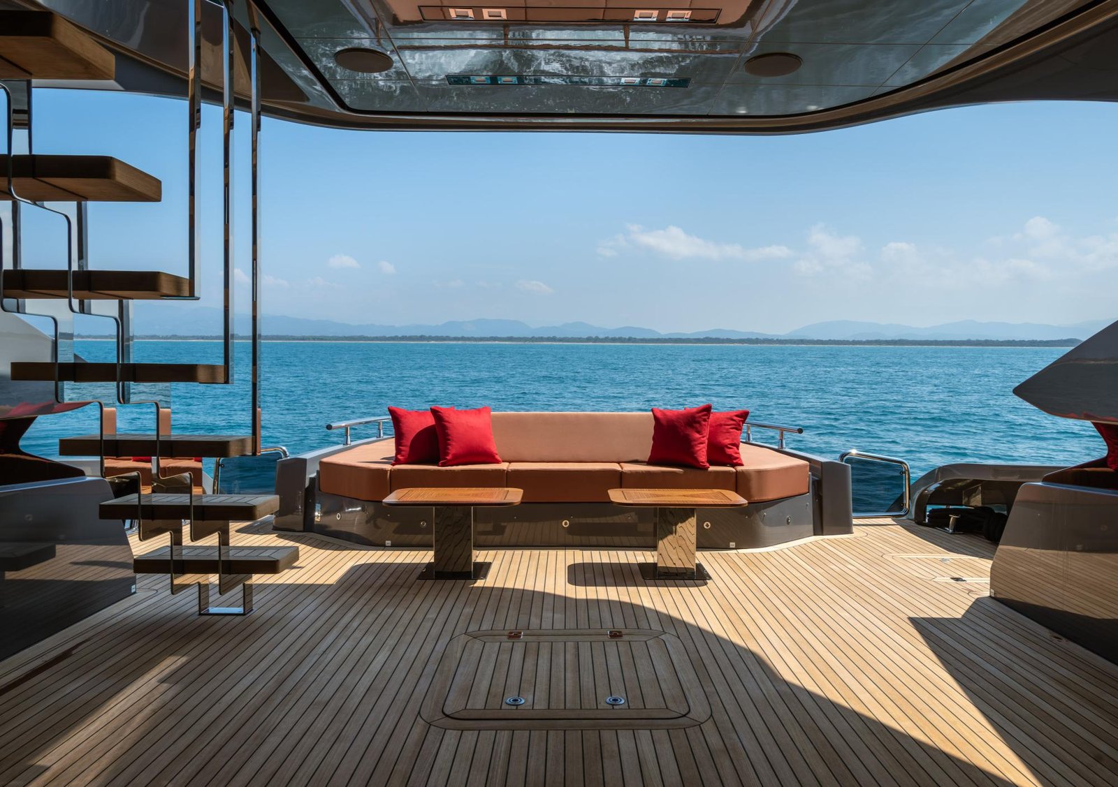 Yacht deck with lounge seating and Mediterranean views
