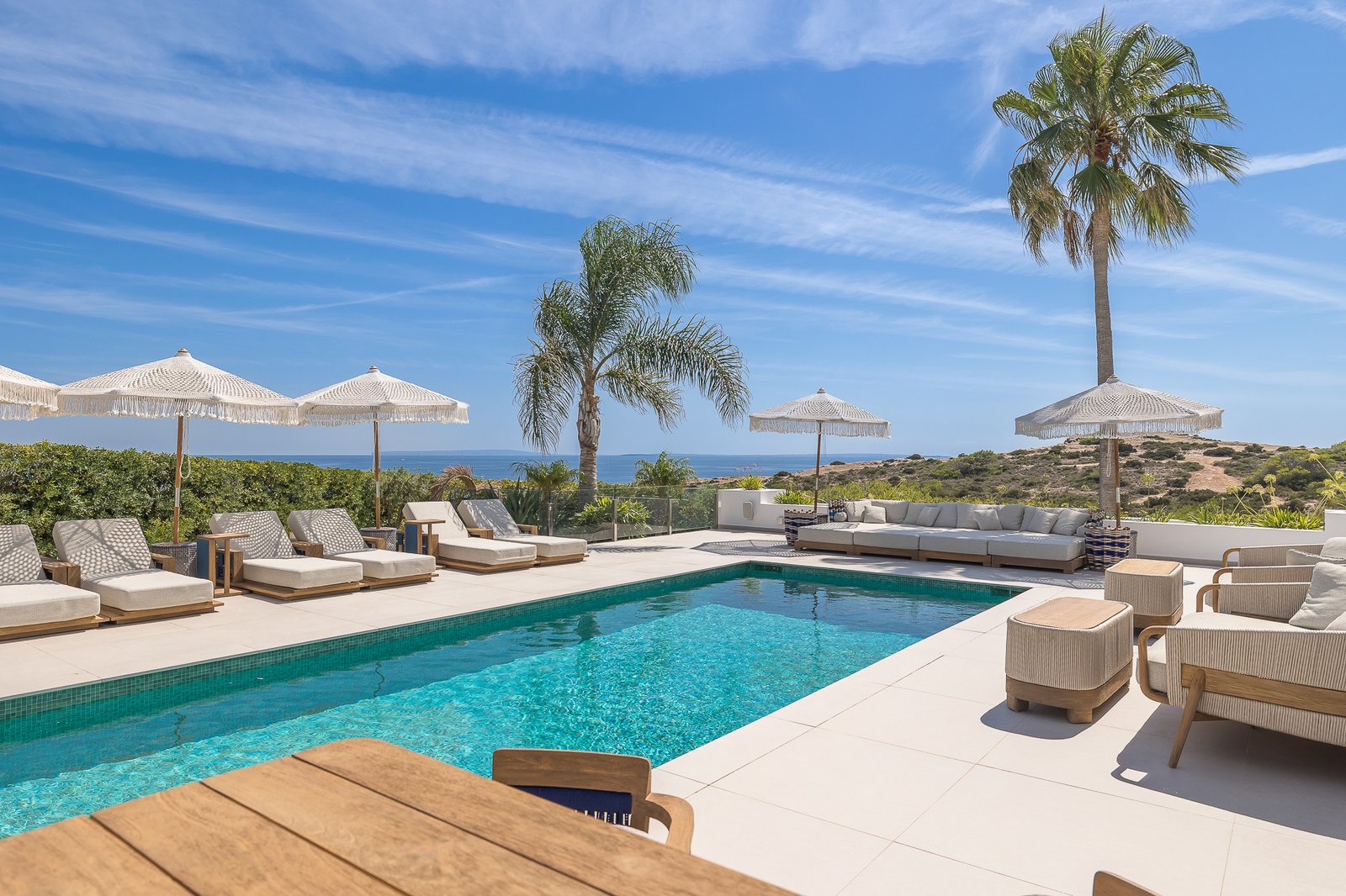 Private villa pool with palm trees and sea views in Ibiza