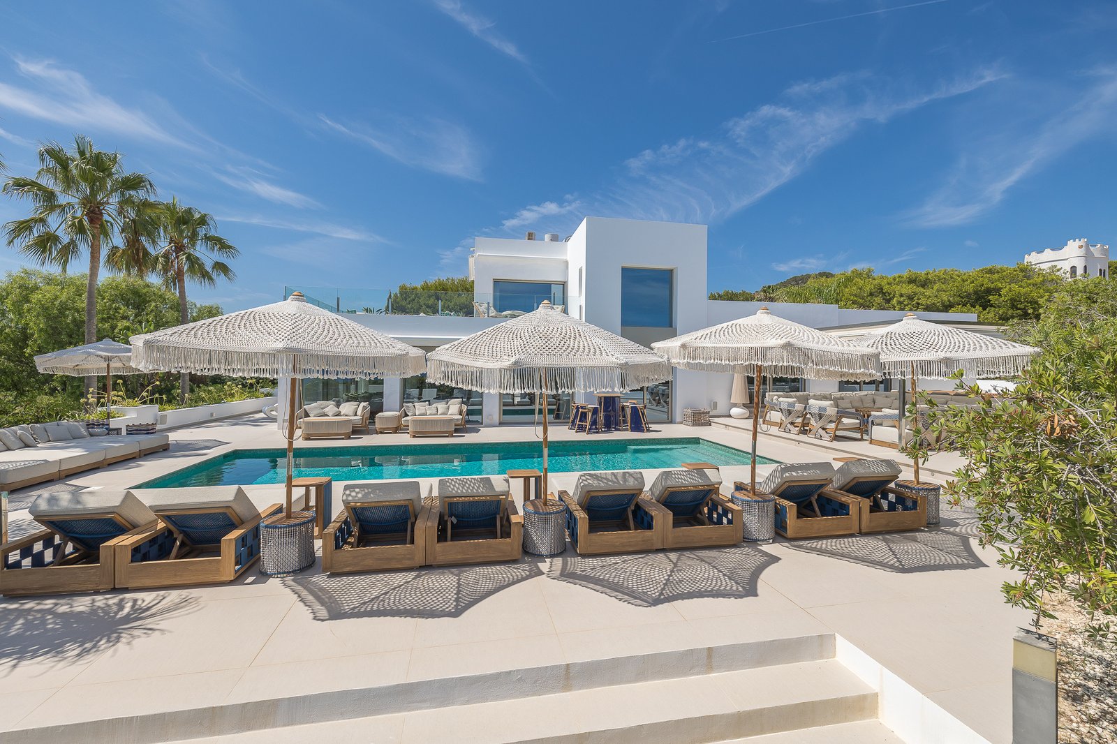 Modern luxury villa with pool and sun loungers in Ibiza